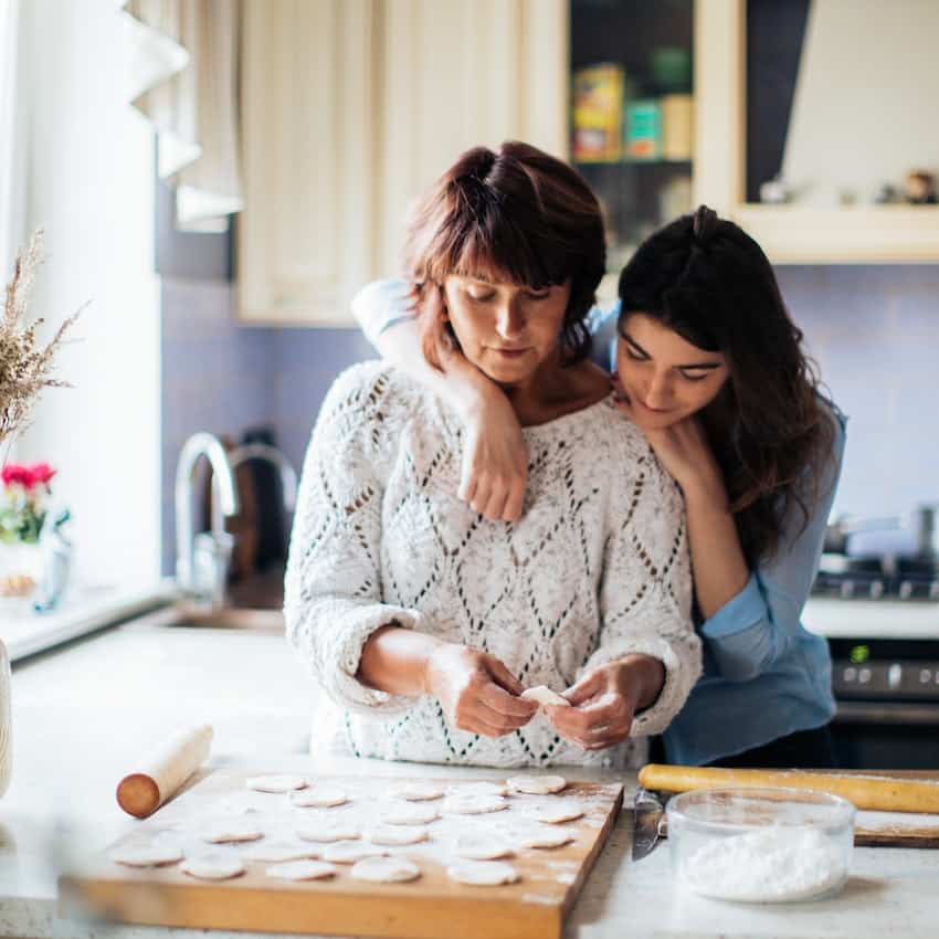 Mom and daughter cooking in the kitchen. mother's day activity ideas.