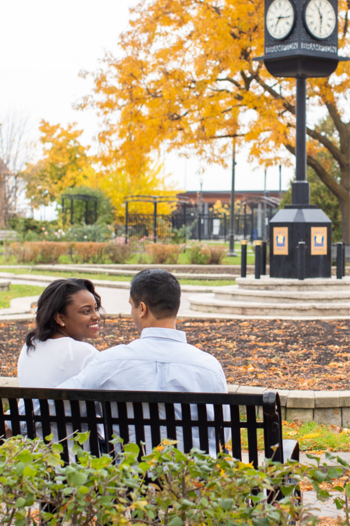 photo of a guy and girl sitting on a bench. Fall date ideas for couples. 