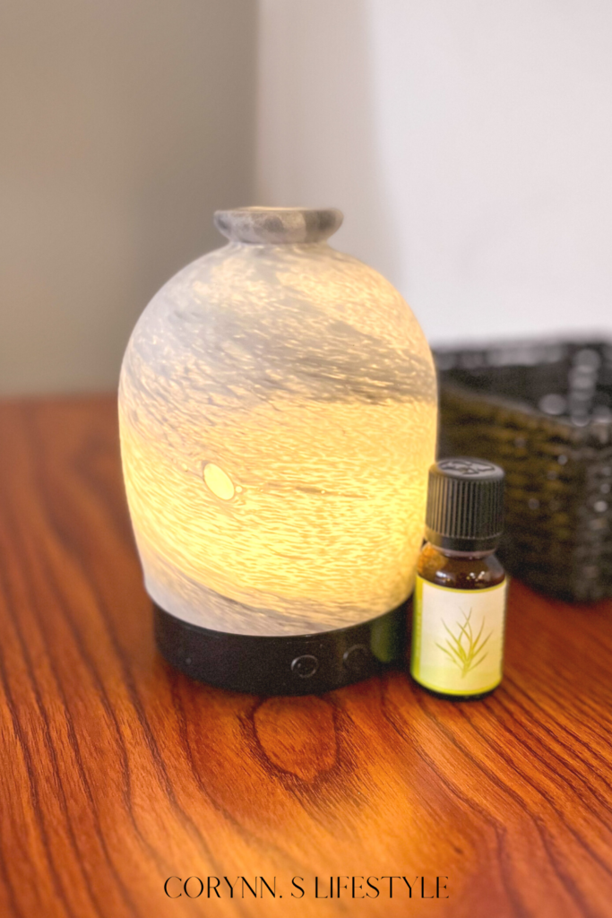 photo of a diffuser and a bottle of essential oils. Smell hacks for home.